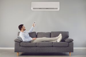 Man reclining on couch with heat pump.