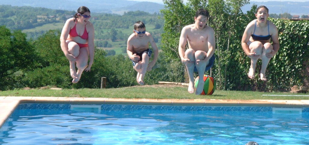 A family enjoying their heated swimming pool