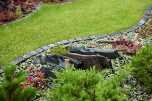 A beautifully lush garden featuring stunning stone accents and a variety of vibrant flora