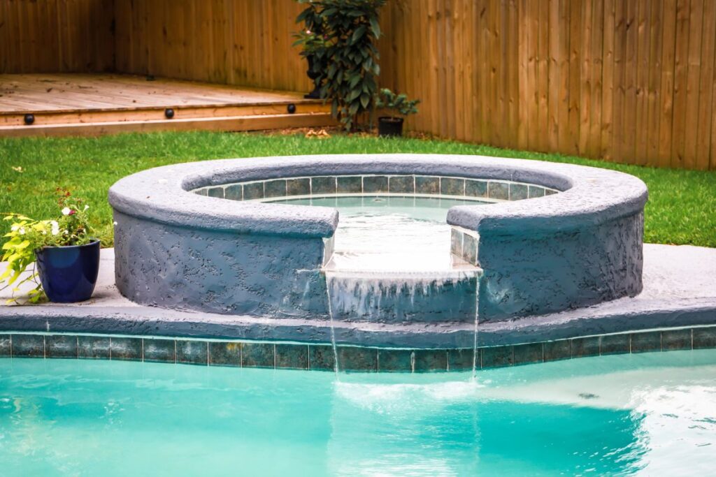 spa pool with fountain feature by pool