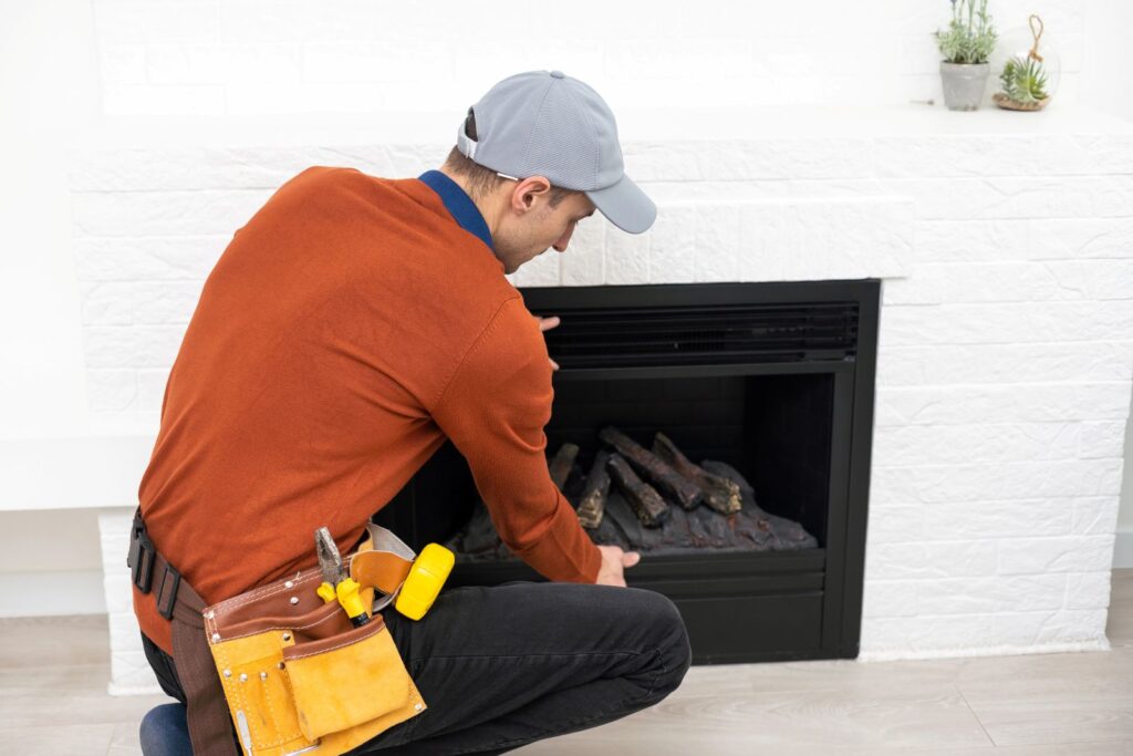 man fixing fireplace